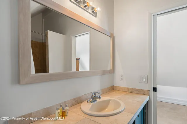 a bathroom with a sink and a mirror