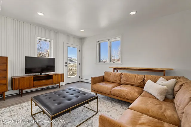 a living room with furniture and a flat screen tv