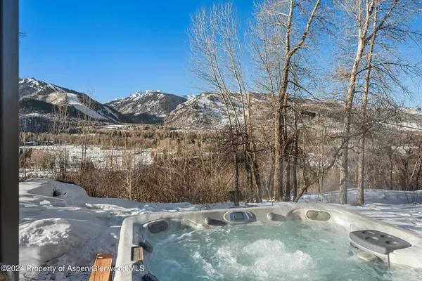 a view of a backyard with wooden fence