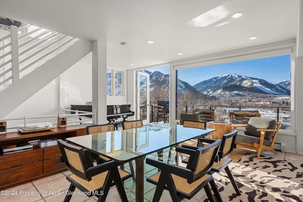 a dining room with furniture and wooden floor
