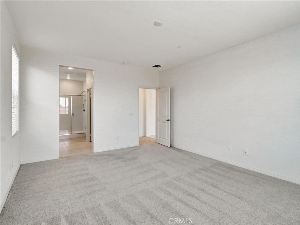 43885 Arancia Way Indio, CA 92203 - Photo 12 of 26 a view of an empty room with closet and a window