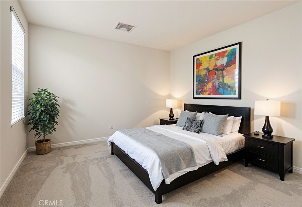 43885 Arancia Way Indio, CA 92203 - Photo 14 of 26 a bedroom with a bed and a painting on the wall