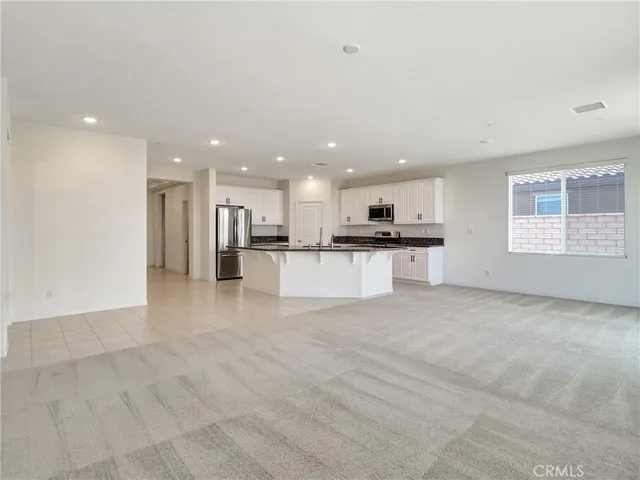 a view of kitchen with refrigerator sink and stove