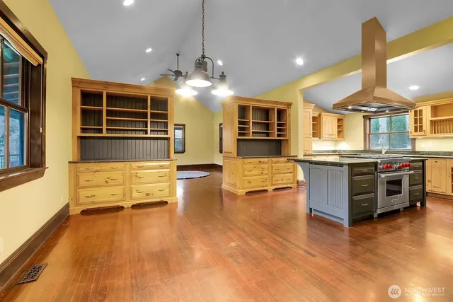 a kitchen with stainless steel appliances granite countertop a sink and wooden cabinets