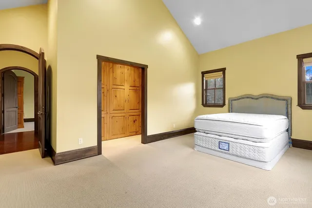 a spacious bedroom with a bed and wall painting