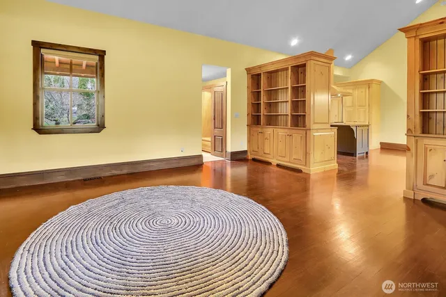 an open kitchen with granite countertop a stove top oven a sink and dishwasher cabinets with wooden floor