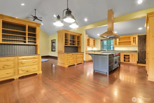a kitchen with stainless steel appliances granite countertop a stove and cabinets