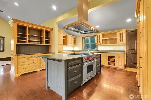a kitchen with stainless steel appliances granite countertop a stove and a sink