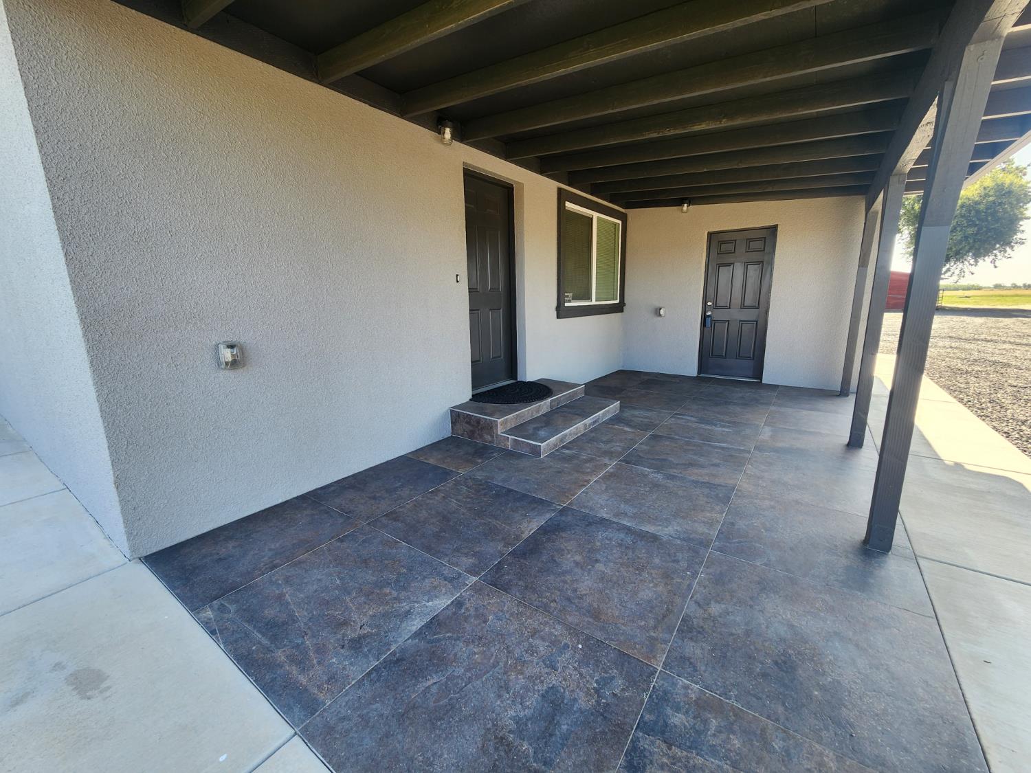 20383 Sutliff Road Escalon, CA 95320 - Photo 14 of 65 a view of a big room with wooden floor and windows