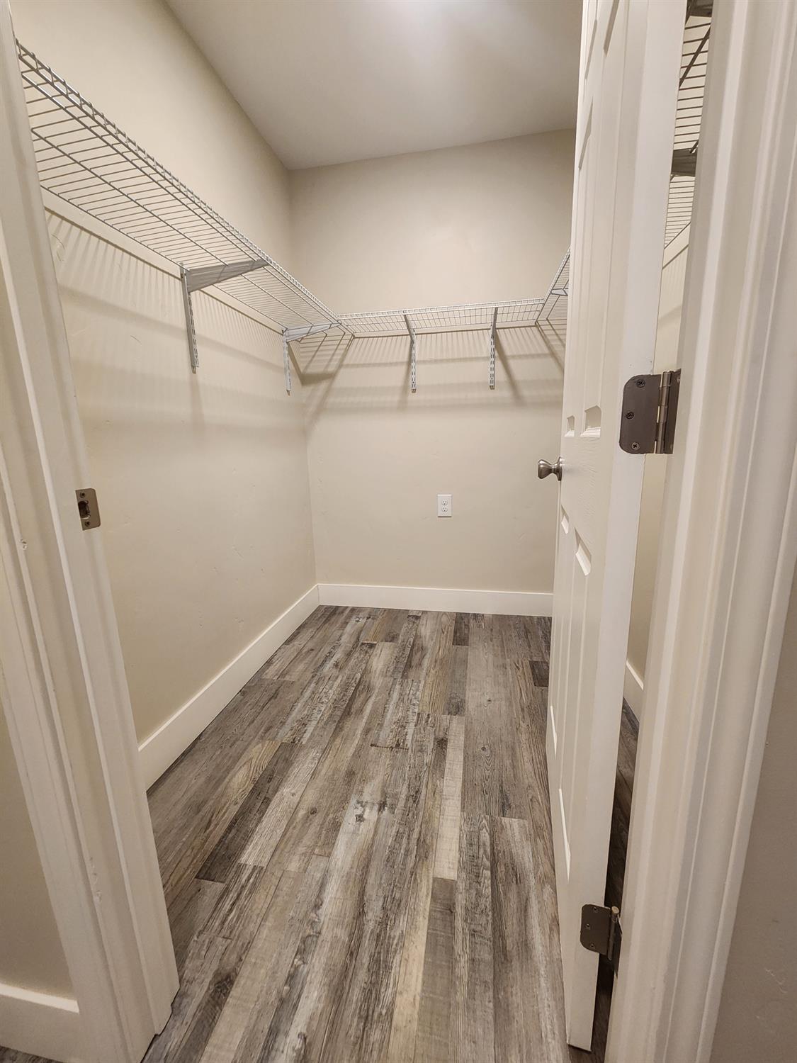 20383 Sutliff Road Escalon, CA 95320 - Photo 17 of 65 a view of a room with wooden floor
