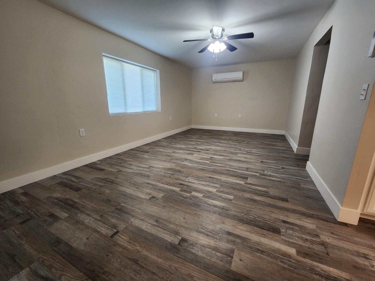 20383 Sutliff Road Escalon, CA 95320 - Photo 18 of 65 wooden floor in an empty room with a window