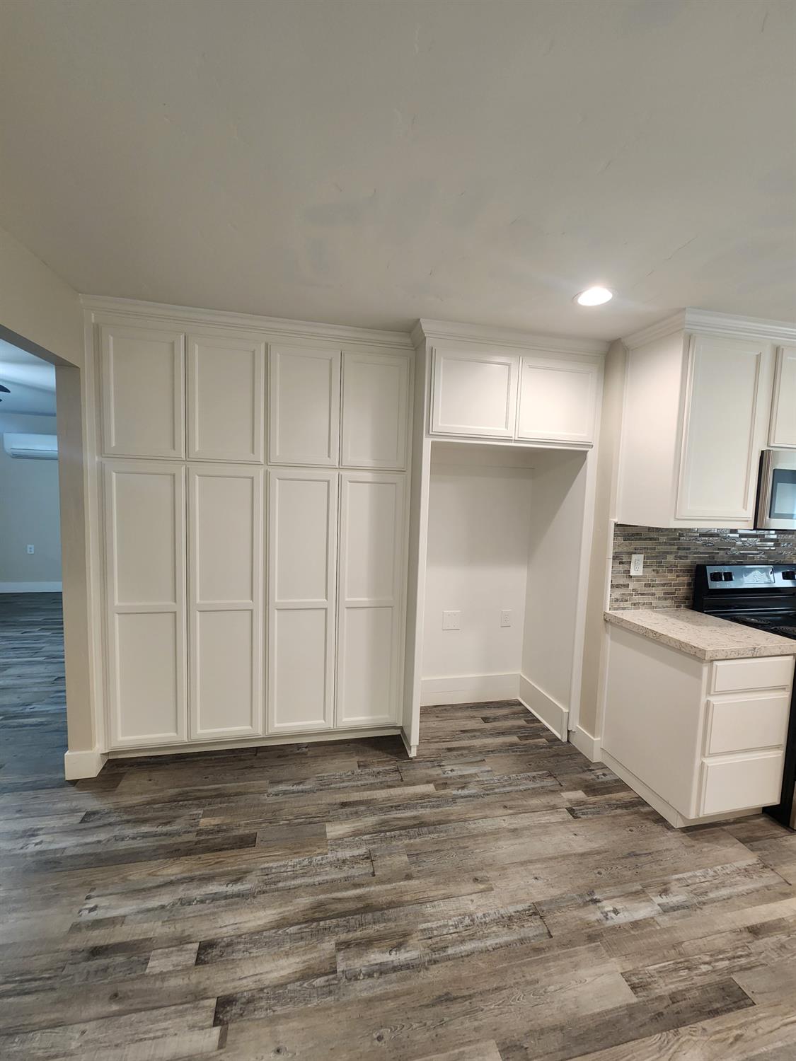 20383 Sutliff Road Escalon, CA 95320 - Photo 20 of 65 a view of kitchen and empty room with wooden floor