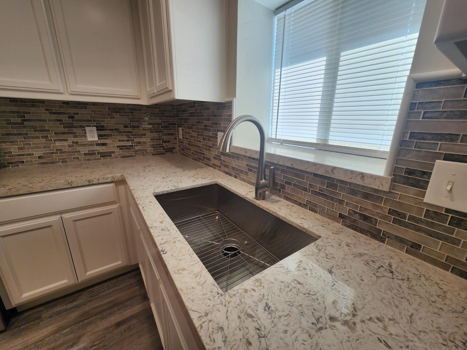 20383 Sutliff Road Escalon, CA 95320 - Photo 21 of 65 a kitchen with granite countertop a sink a stove and cabinets