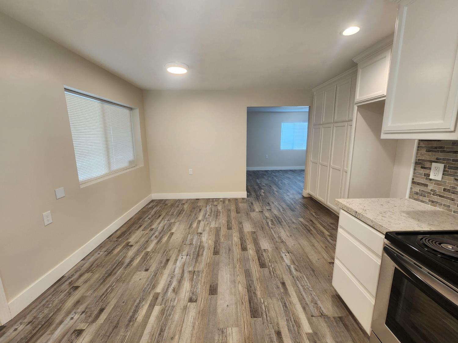 20383 Sutliff Road Escalon, CA 95320 - Photo 23 of 65 a view of a kitchen with wooden floor and a sink