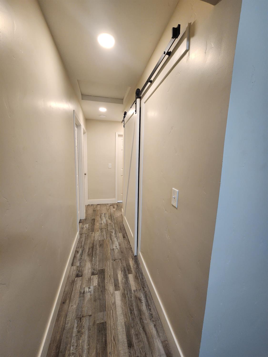 20383 Sutliff Road Escalon, CA 95320 - Photo 24 of 65 a view of hallway with wooden floor