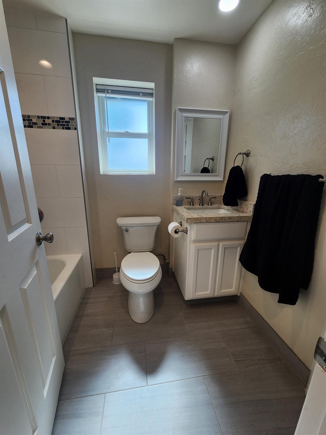 20383 Sutliff Road Escalon, CA 95320 - Photo 27 of 65 a bathroom with a toilet sink and mirror
