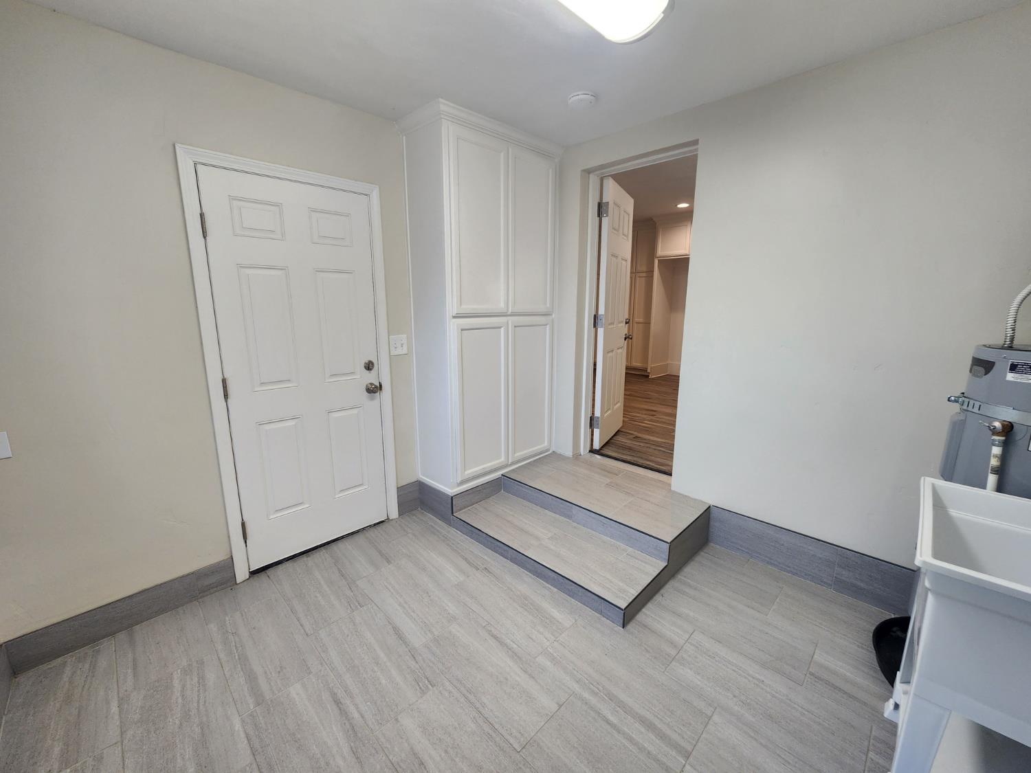 20383 Sutliff Road Escalon, CA 95320 - Photo 32 of 65 an empty room with wooden floor and windows