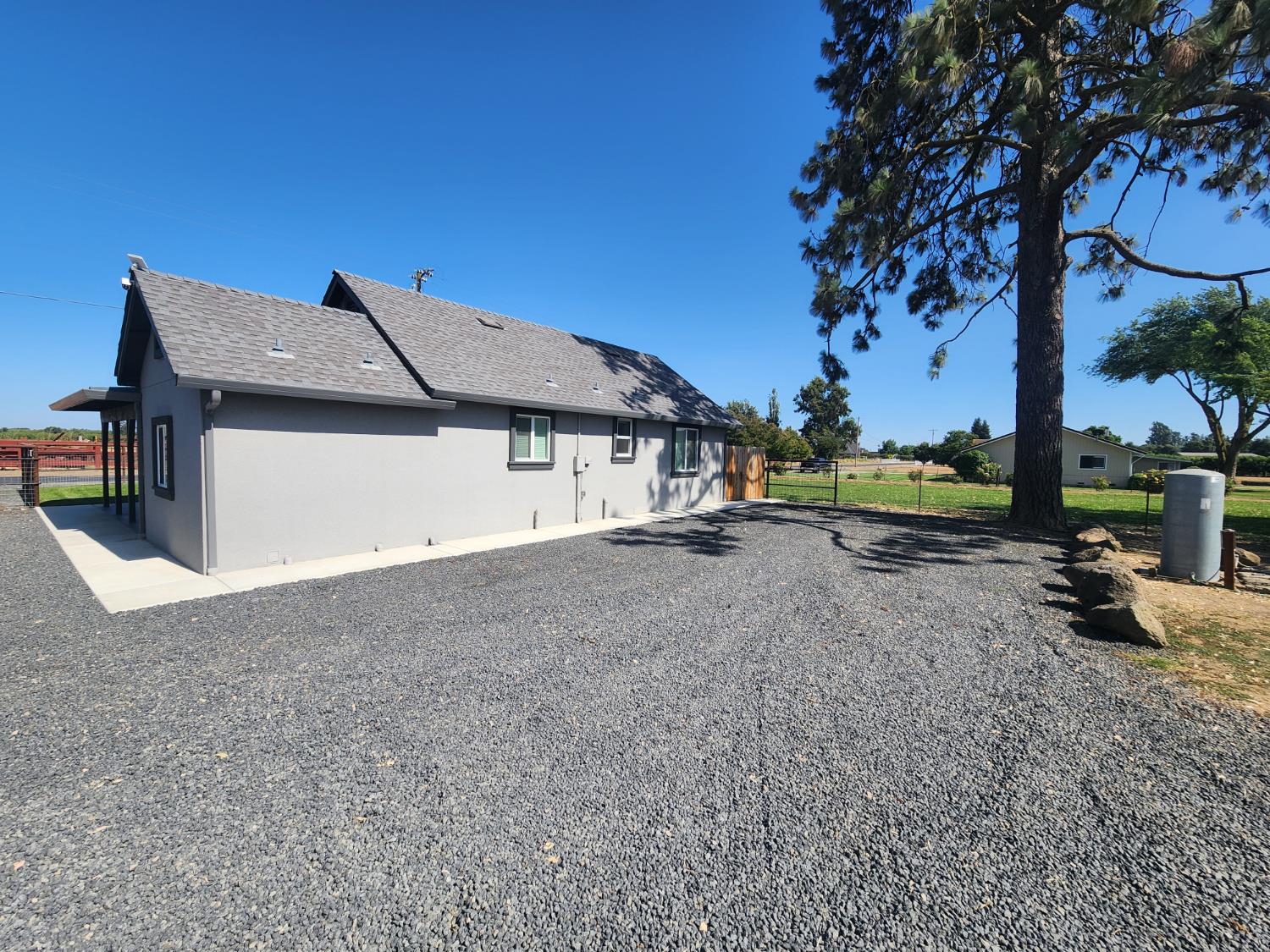 20383 Sutliff Road Escalon, CA 95320 - Photo 9 of 65 a view of a house with a yard and sitting area