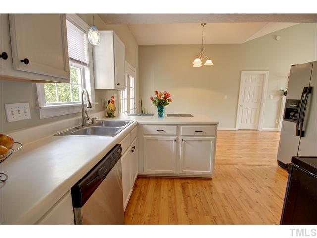 9509 Dawnshire Road Raleigh, NC 27615 - Photo 11 of 24 a kitchen with a sink cabinets and window