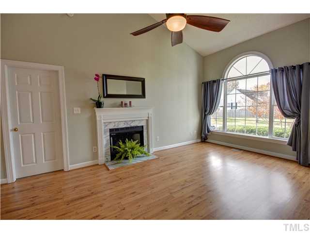 9509 Dawnshire Road Raleigh, NC 27615 - Photo 6 of 24 a view of empty room with wooden floor and fireplace