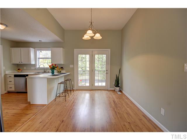 9509 Dawnshire Road Raleigh, NC 27615 - Photo 8 of 24 a view of a kitchen with wooden floor and a window