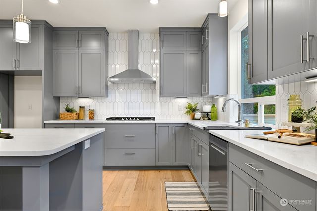a kitchen with a sink stove and cabinets