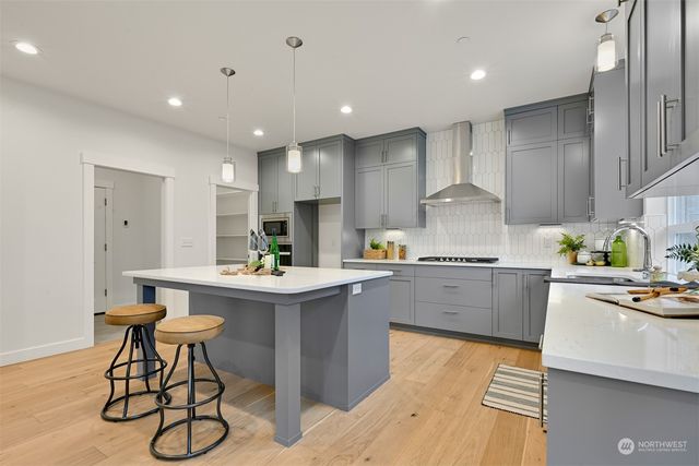 a kitchen with stainless steel appliances kitchen island granite countertop a sink and cabinets