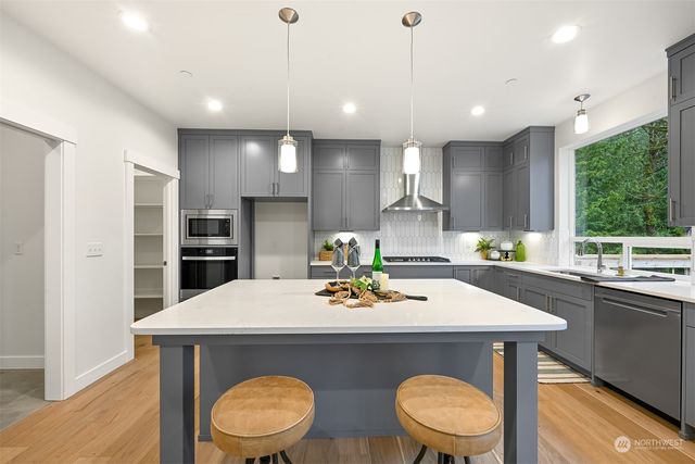 a kitchen with a table chairs stove and refrigerator