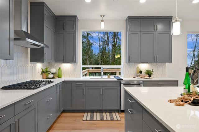 a kitchen with a sink stove and cabinets