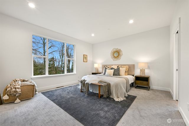 a spacious bedroom with a bed and a couch