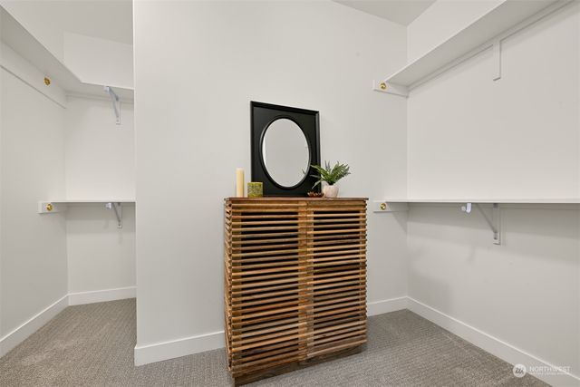 a view of a room with wooden floor and white wall