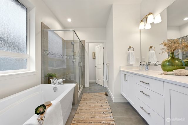 a bathroom with a tub sink and mirror