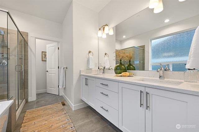 a spacious bathroom with a double vanity sink shower and a mirror