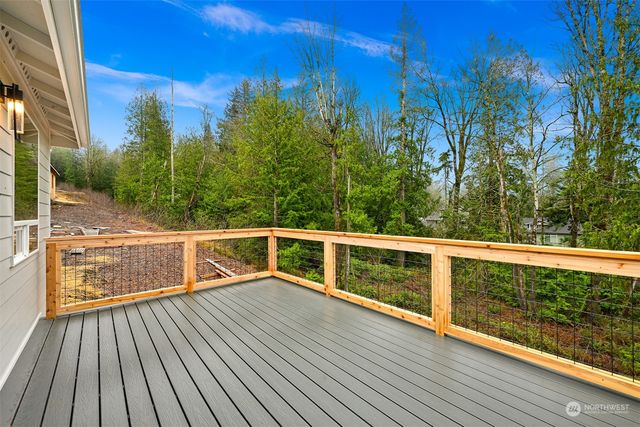 a view of balcony with wooden floor and fence