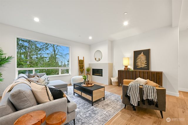 a living room with furniture fireplace and window
