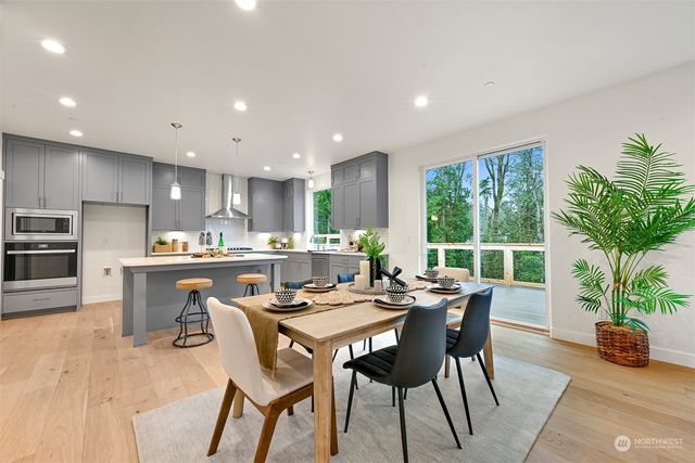 a kitchen with a table and chairs in it