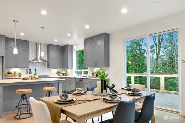 a kitchen with a table chairs stove and cabinets