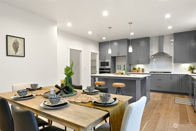 a kitchen with a table chairs stove and kitchen island