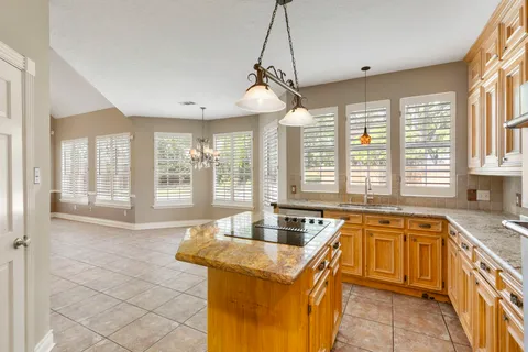 a spacious bathroom with a granite countertop tub and a large window