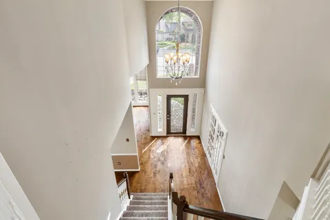 a view of an empty room with furniture and a fireplace