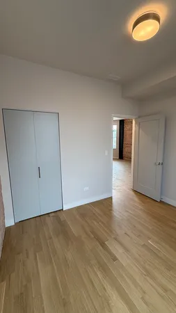 a view of an empty room and wooden floor