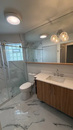 a bathroom with a sink toilet and shower