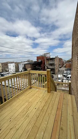 a view of a balcony with wooden floor