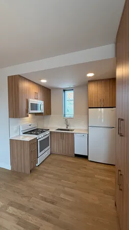 a kitchen with stainless steel appliances a refrigerator and a stove top oven