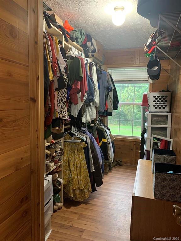 2632 Beaverdam Road Canton, NC 28716 - Photo 11 of 18 a view of walk in closet with clothes and shoes