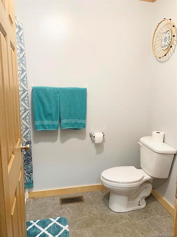 2632 Beaverdam Road Canton, NC 28716 - Photo 13 of 18 a bathroom with a toilet and a shower