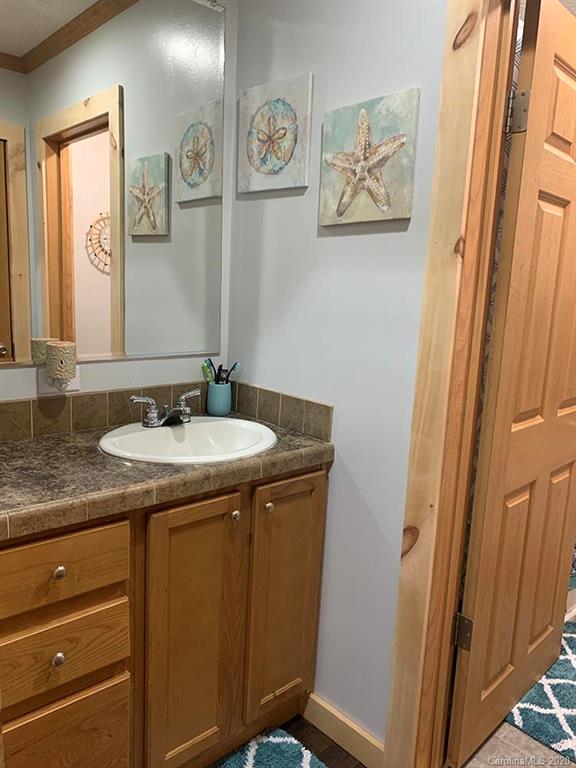 2632 Beaverdam Road Canton, NC 28716 - Photo 14 of 18 a bathroom with a granite countertop sink and a mirror