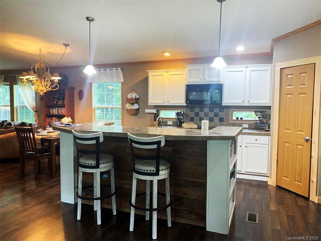 2632 Beaverdam Road Canton, NC 28716 - Photo 3 of 18 a kitchen with a dining table chairs and view kitchen