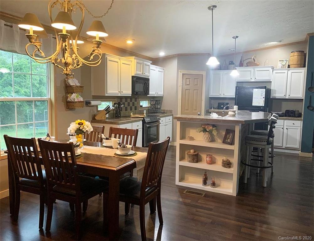 2632 Beaverdam Road Canton, NC 28716 - Photo 5 of 18 a view of a dining room with furniture window and wooden floor