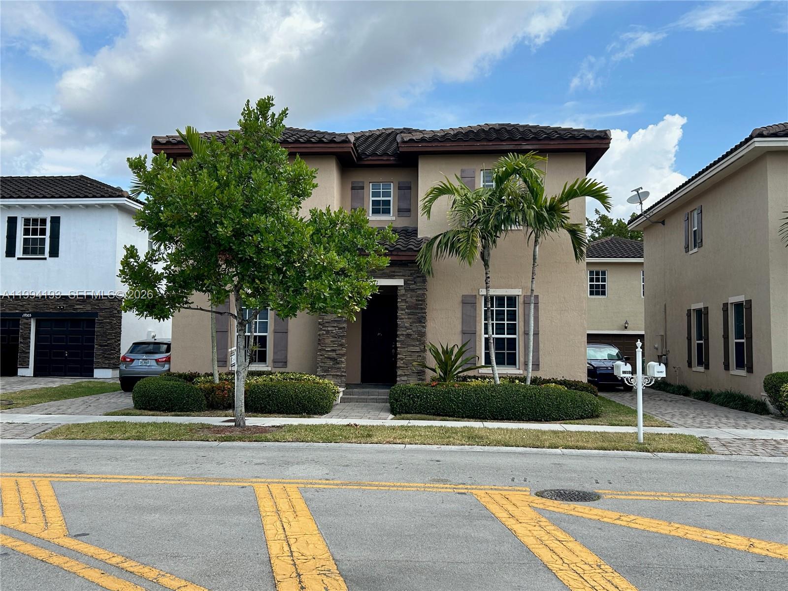 17001 Southwest 90th Terrace, Unit 1 Miami, FL 33196 - Photo 1 of 35 a view of a house with a patio